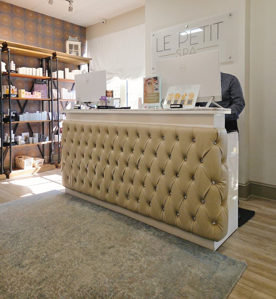 Reception at Le Petit Spa Ballantyne, with the studio's retail shelving behind the front desk